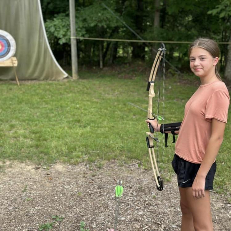  Youth practices archery at 4-H Camp